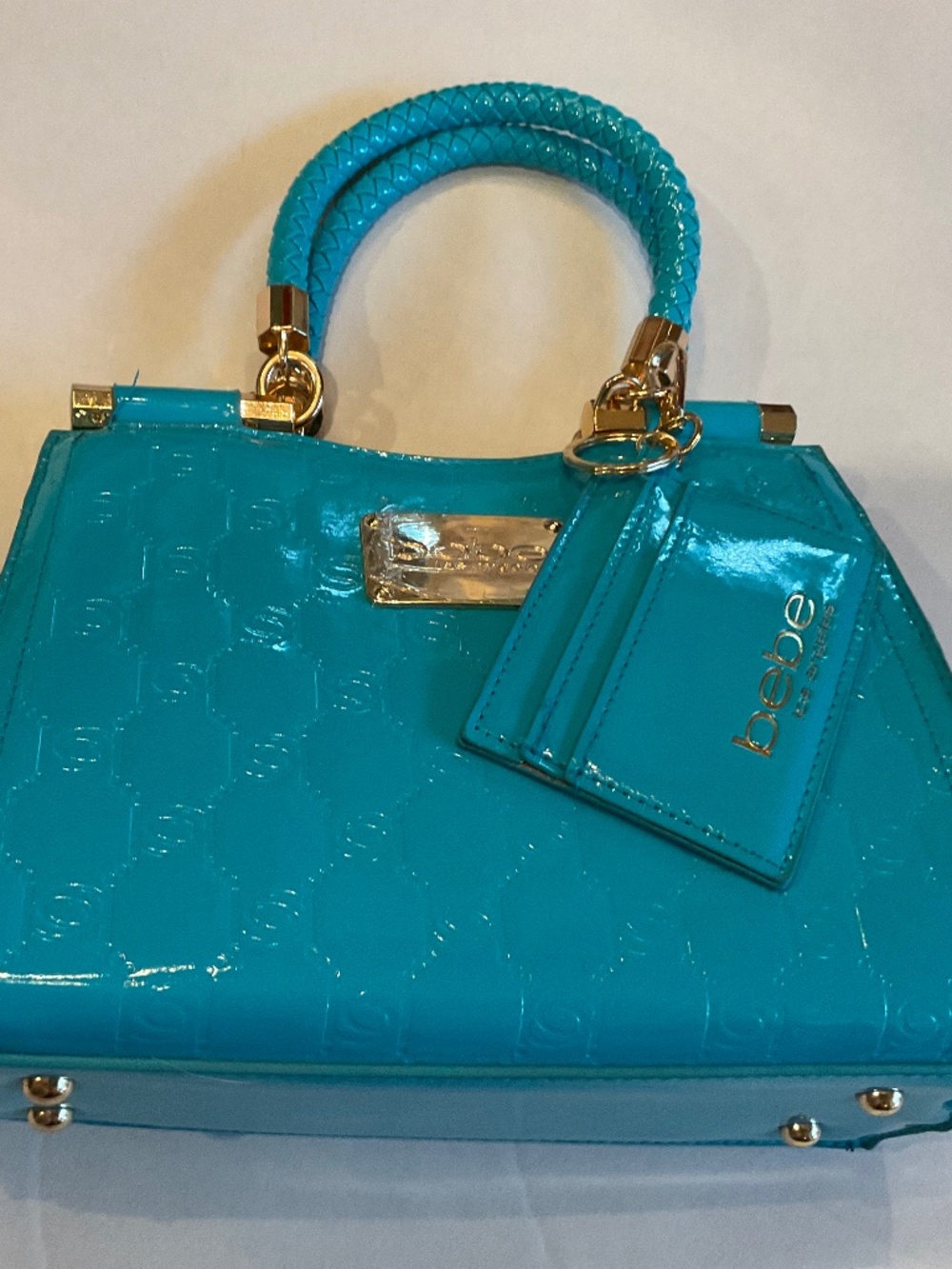 NWOT Bebe Dana capri blue leather-like crossbody with 6” braided top handles.